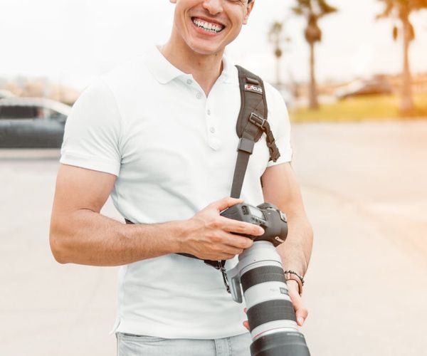 Person smiling and stretching in a park on a sunny day.